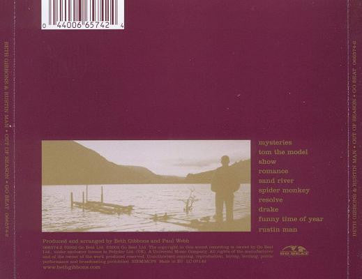 The back cover of a music CD for 'Mysterieties' by Keith Gibbons and Paul White, featuring a deep burgundy background, a central sepia-toned photograph of a dock and figure silhouette, and tracklist text on the right.