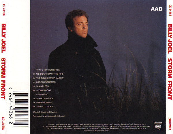 Billy Joel - Storm Front CD album cover and spine, showing a dark portrait of the artist in a black coat against a moody blue-gray background, with tracklist, barcode, and AAD/Columbia branding.