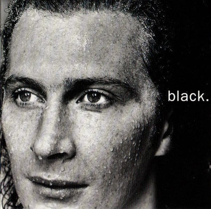 A close-up black and white portrait of a man's face with the word 'black.' printed in white on the right side.