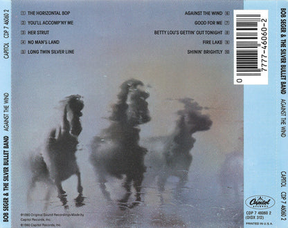 Back cover of a CD release for Bob Seger and the Silver Bullet Band's album 'Against the Wind', featuring a misty, low-contrast photograph of three horses in the center, tracklist on the left, barcode on the right, and Capitol Records branding at the bottom.