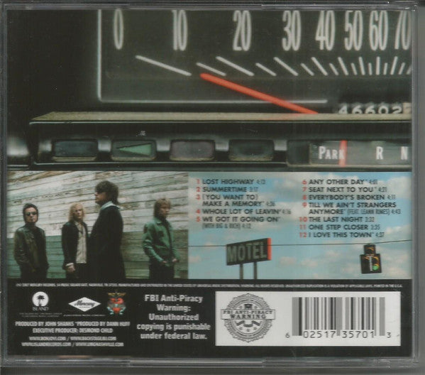 The back cover of a CD case for Bon Jovi's Lost Highway  featuring the album tracklist, barcode, and a photo of the band members.