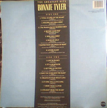 The back cover of a Bonnie Tyler CD, featuring a light blue background with a large black vertical tracklist panel and gold text.