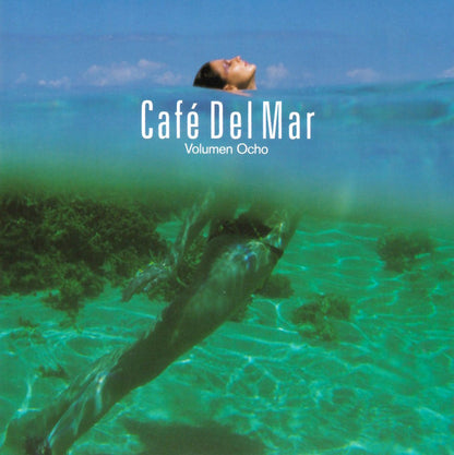 Album cover for 'Café Del Mar Volumen Ocho' featuring a split underwater scene: a woman's face at the water surface above and an underwater view of her body below in turquoise-green ocean water.