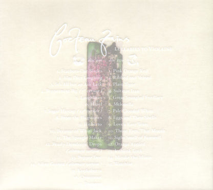 A close-up of a light cream-colored surface with faint printed text and a small central illustration of a green bottle with pink floral artwork.