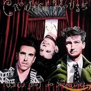 Album cover art for 'Crazy House' featuring three men in front of red curtains, with stylized text and a dark illustrated background.