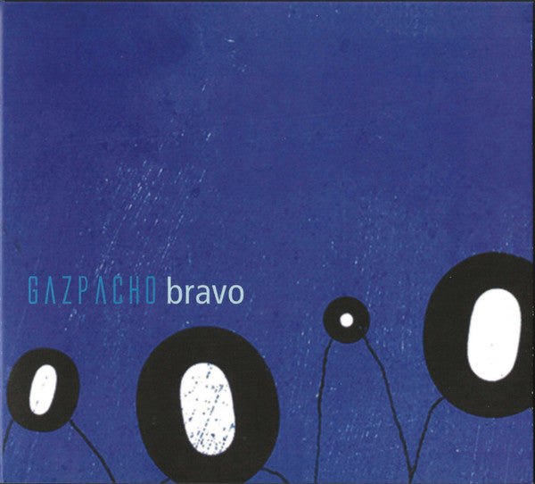 Album cover for Gazpacho Bravo, featuring a textured deep blue background with black circular shapes containing white centers and the text 'GAZPACHO bravo' in light blue and white.