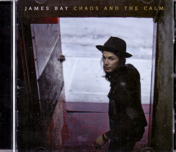 Album cover for 'Chaos and the Calm' by James Bay with a person in a hat and coat.