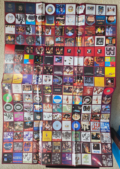 Large collection of compact disc covers displayed on a flat surface.