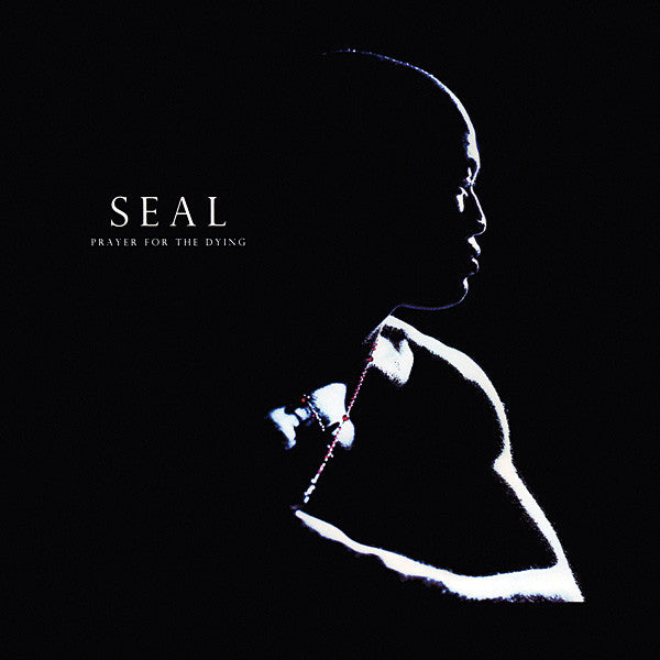 Album cover for 'Prayer for the Dying' by the band SEAL, featuring a high-contrast silhouette of a person in profile against a solid black background, with the band name and album title in white text on the left.