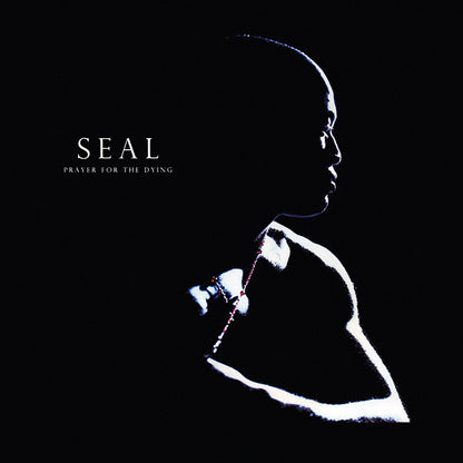 Album cover for 'Prayer for the Dying' by the band SEAL, featuring a high-contrast silhouette of a person in profile against a solid black background, with the band name and album title in white text on the left.