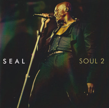 Seal 'Soul 2' album cover featuring a live performance photo of the artist singing into a microphone, with 'SEAL' and 'SOUL 2' text on a dark background.