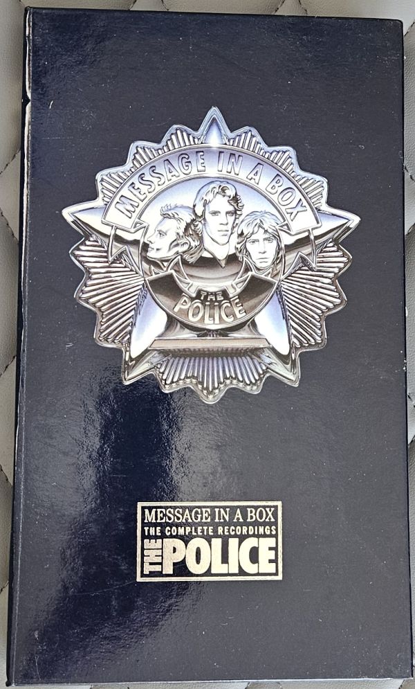 The Police 'Message in a Box: The Complete Recordings' box set cover, featuring a silver police badge emblem and the band's name on a black background.