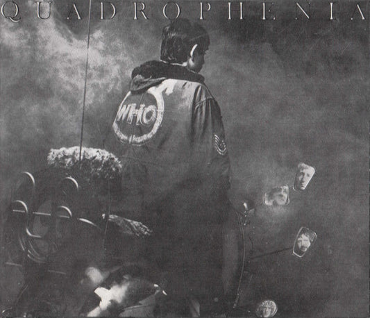 Black and white album cover art for 'Quadrophenia' featuring a person from behind wearing a jacket with a large 'WHO' logo on the back, seated in a car with mirrors and smoke visible.