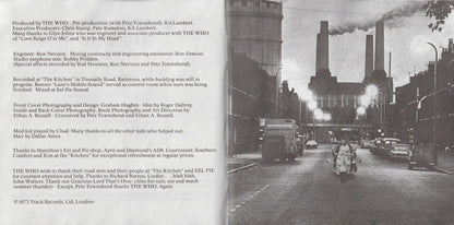 A printed booklet or album insert with a black-and-white street photograph on the right and extensive production credits and track listing text on the left, photographed against a dark background.
