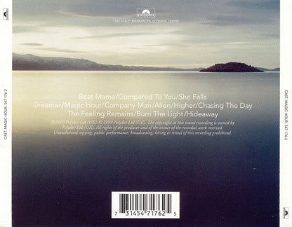The back cover of a Cast Music 'Magic Hour' CD, featuring a scenic photograph of a calm lake with mountains under a hazy sky. White text displays track listings, and a barcode is located at the bottom.