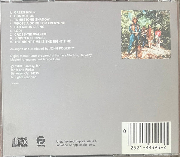 Back cover of a CD album for 'Green River' by John Fogerty, featuring a gray background, tracklist on the left, a small illustrated cover photo on the right, and a barcode in the bottom right corner.